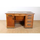 Oak Art Deco desk with 5 drawers, panel door behind which 3 internal drawers and folding lower