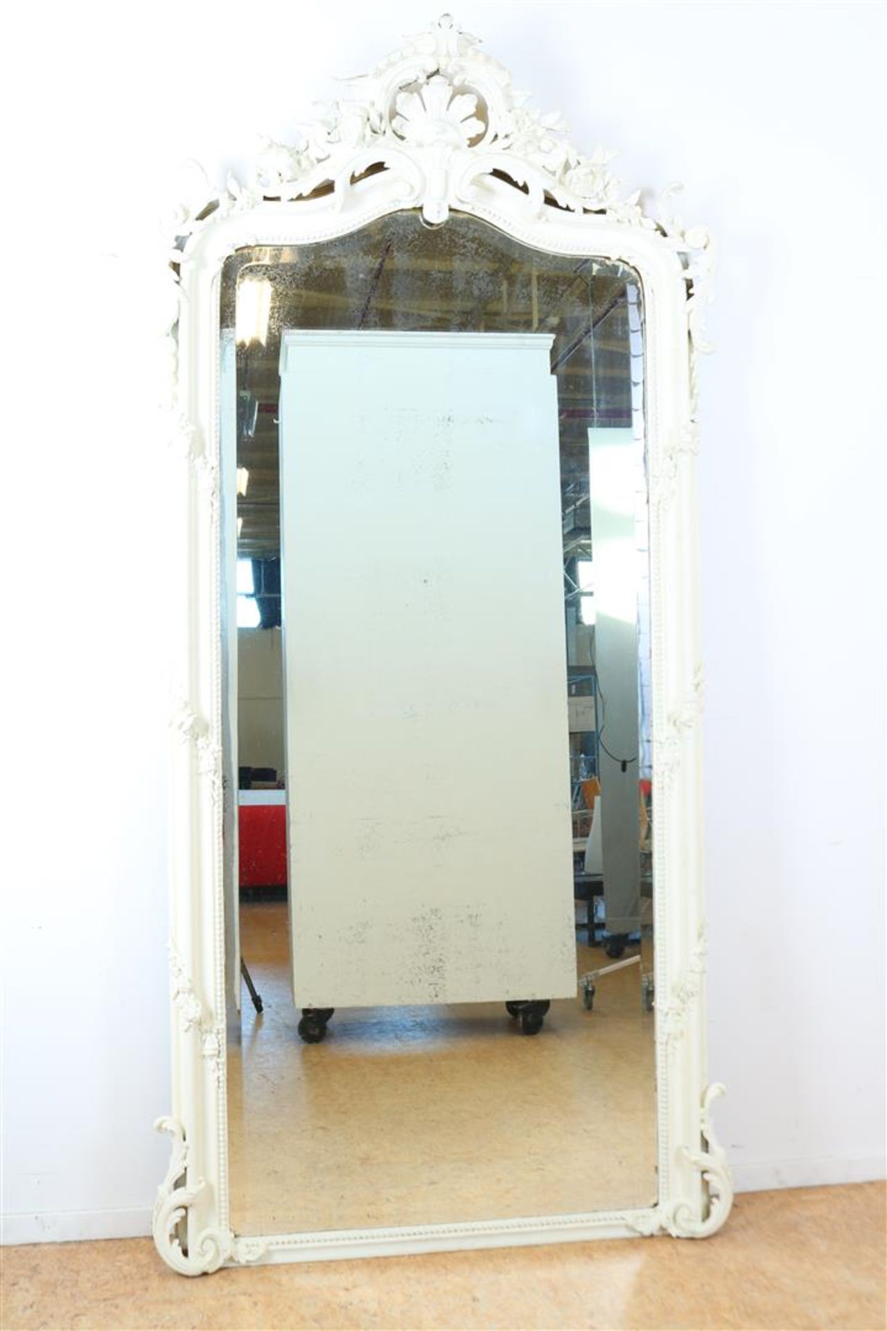 Faceted mirror in white frame with shade.