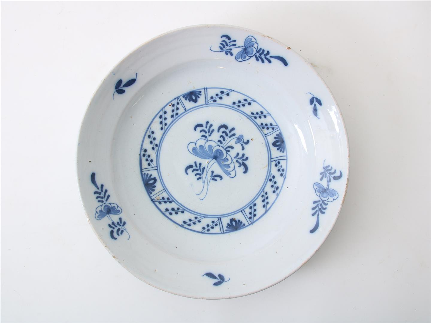 Earthenware dish with central decoration of flowers and border decoration of flowers and leaves,