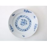 Earthenware dish with central decoration of flowers and border decoration of flowers and leaves,