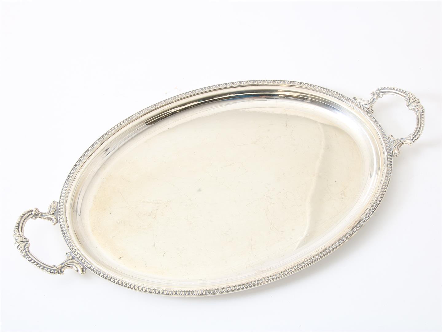 Silver oval tray with palmette edge, with handles with pearl edge, grade 800/000.