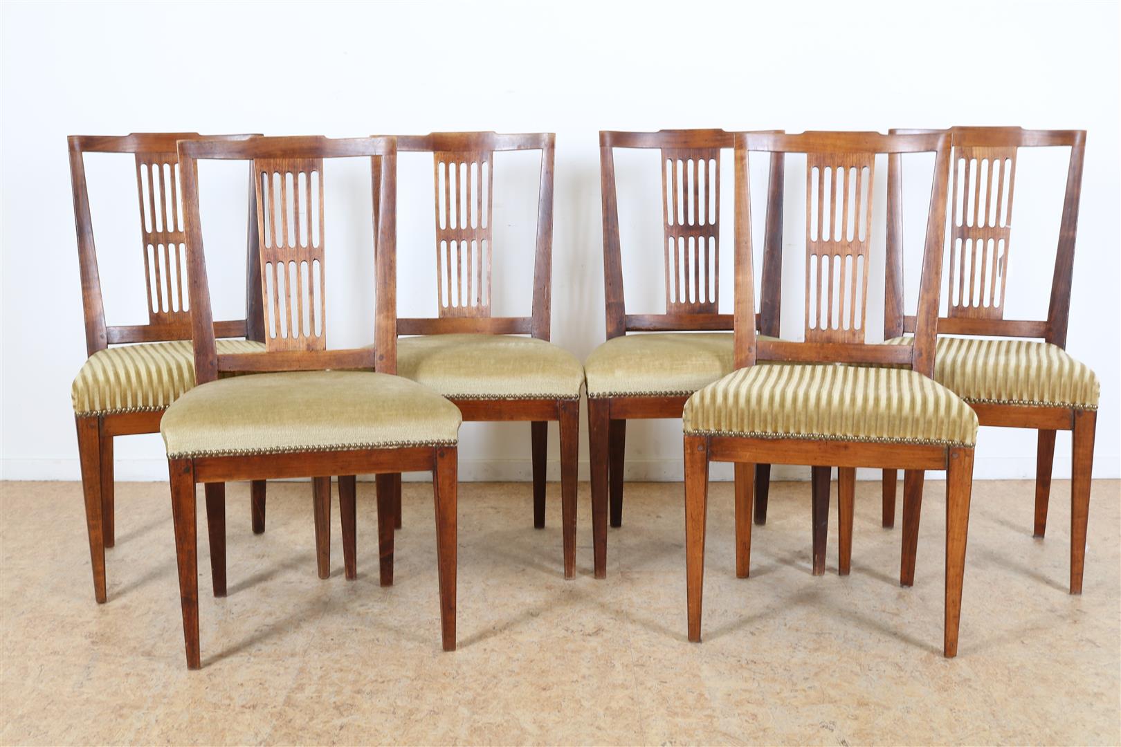 Series of 6 elm wood chairs with elaborate backrest and various green velvet seats, ca. 1800.