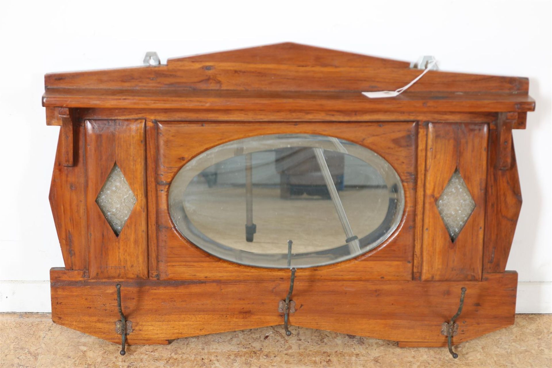 Teak Art Deco wall coat rack with oval cut mirror, Indonesia ca. 1925, 53 x 75 cm.