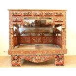 Red and gilded wooden traditional bedstead with carved birds, flowers and dragons, origin Madura,