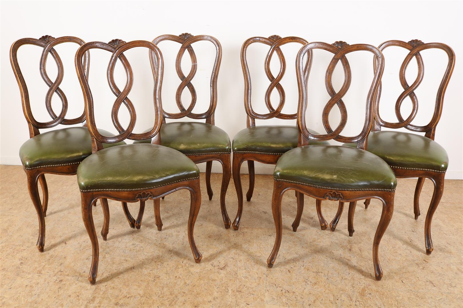 Series of 6 walnut Louis XV style chairs with carved shell motif in crest and green leather seat,