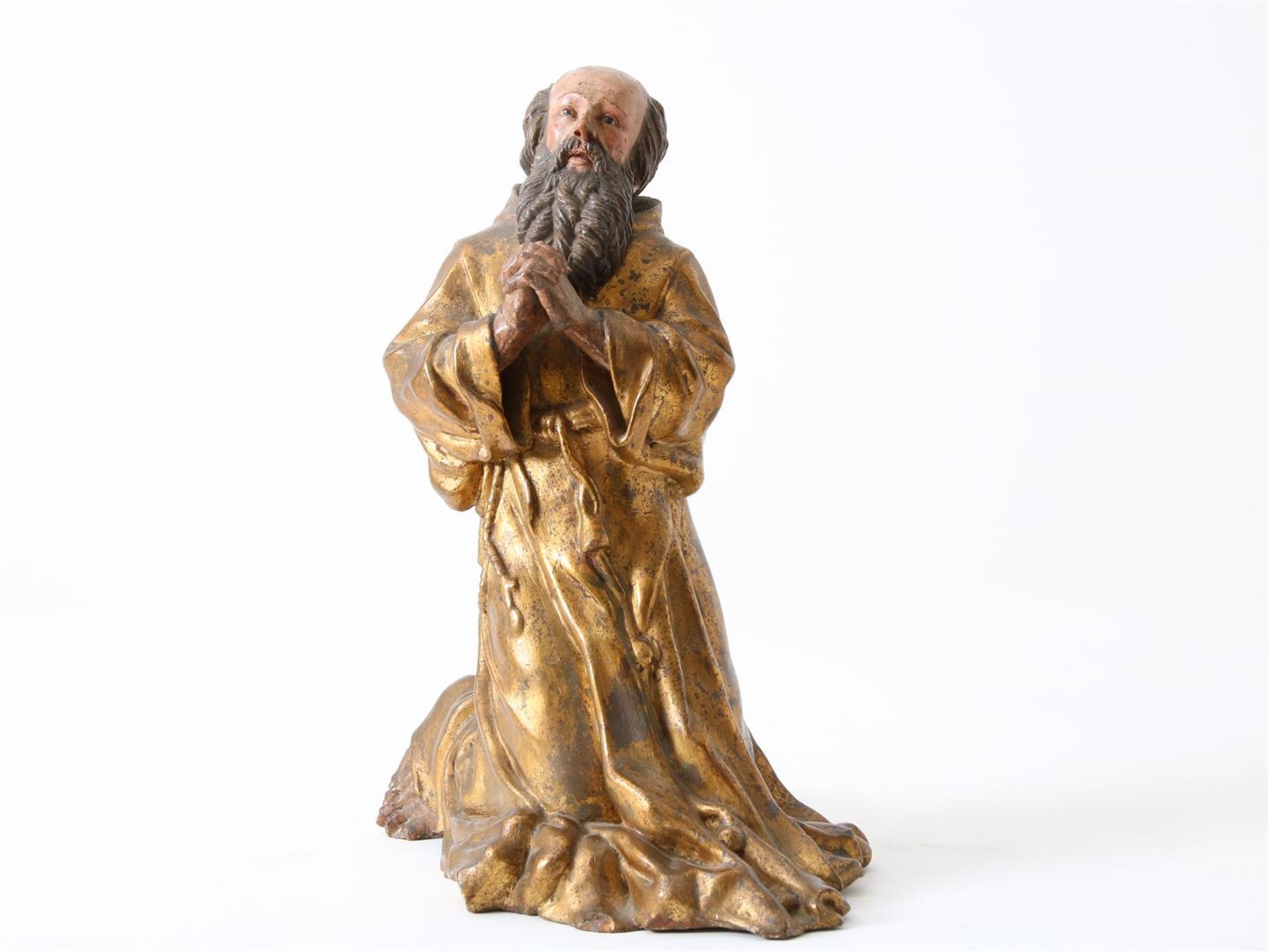 Partly gilded terracotta sculpture of kneeling Saint Francis of Paula (1416-1507) with beard and