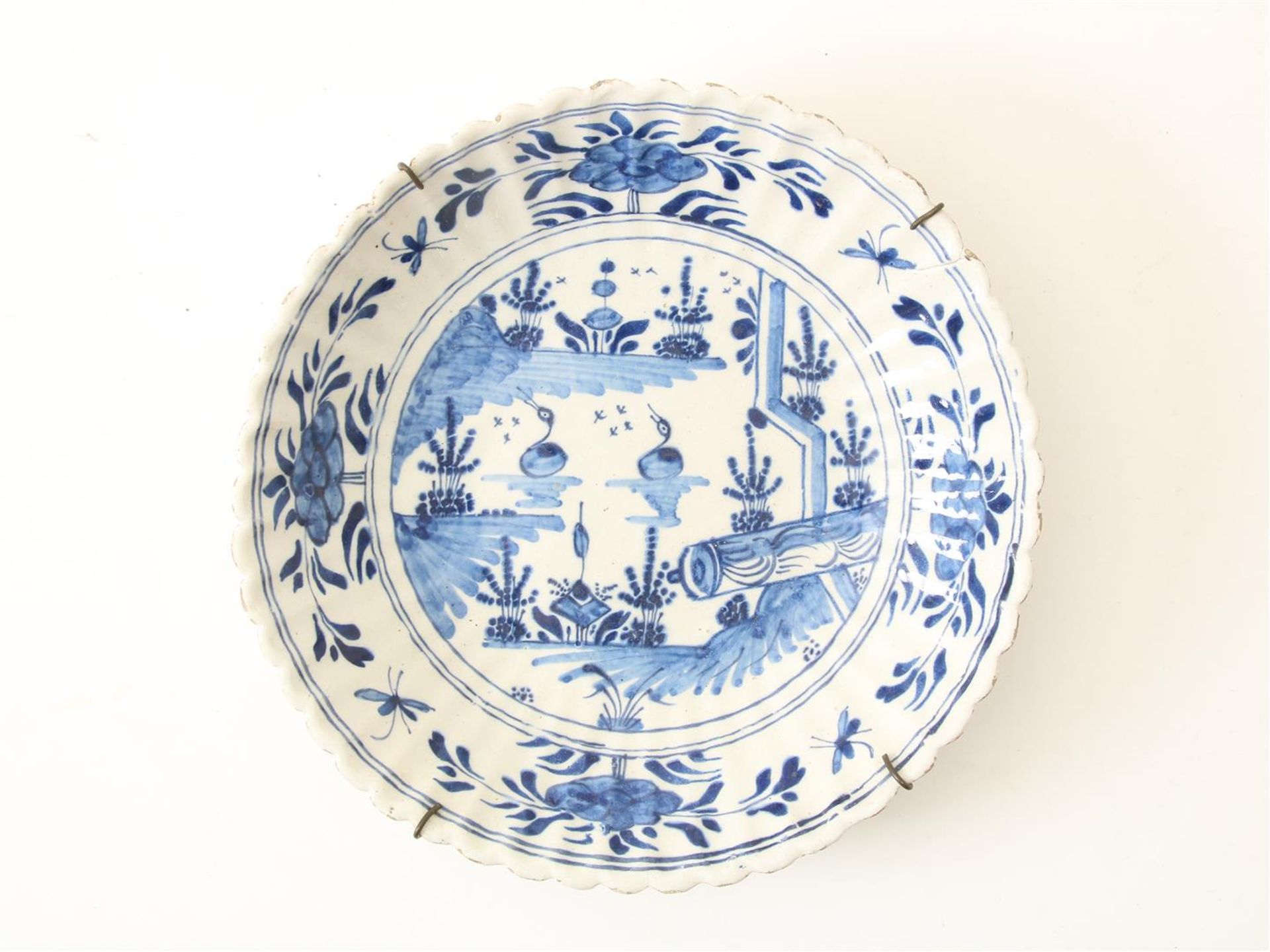 Earthenware dish with serrated edge, decorated with landscape, flowers and birds, Delft 18th