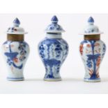 Set of porcelain miniature lidded vases with floral decor, height 10 cm. (edge restored and lids