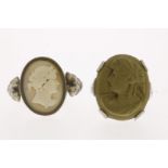 Two silver rings, one with a shell cameo and one with a lava cameo, sizes approximately 17 and 18.