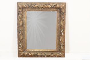 Mirror in richly carved wooden frame