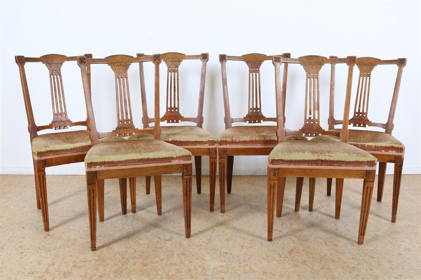 Series of 6 elm wood chairs with elaborate backrest and various green velvet seats, ca. 1800. (