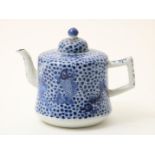 A porcelain teapot, blue decorated with bass decor, China 19th century, height: 12.5 cm.