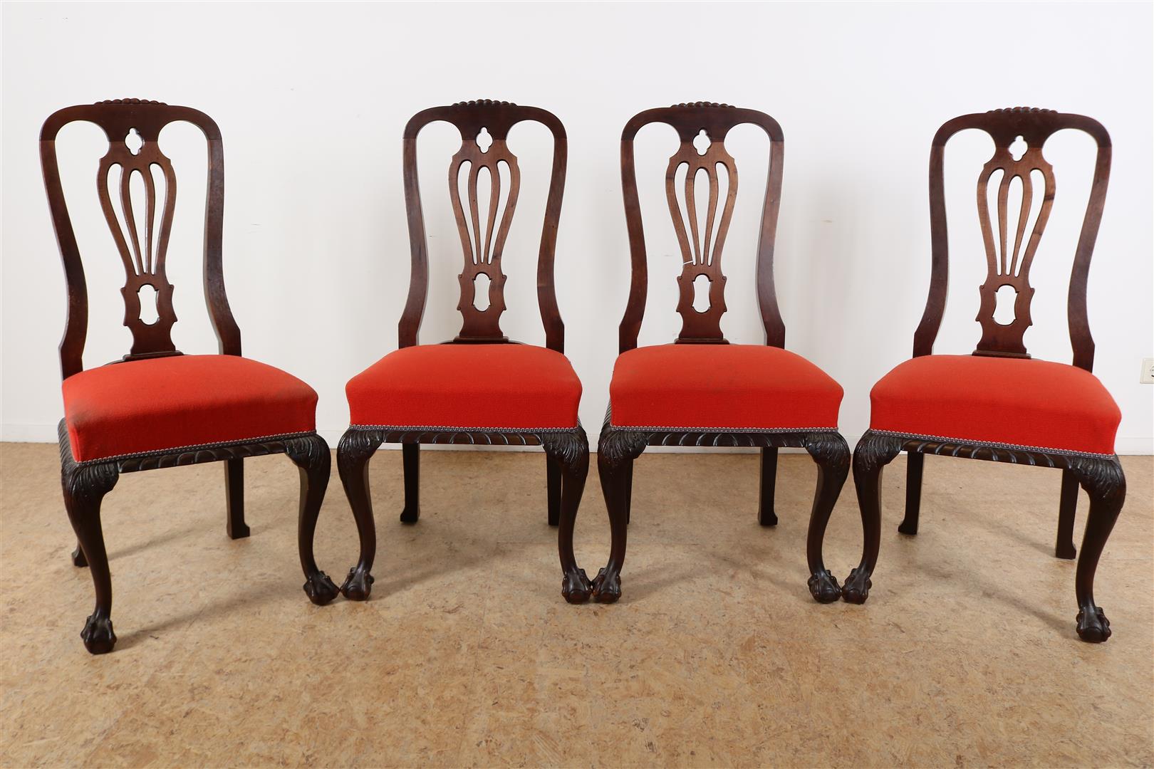 Series of 4 Chippendale-style chairs with elaborate backrest, red fabric seat on ball claw feet,