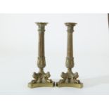 Two brass candlesticks on claw feet, 19th century, height 29 cm.