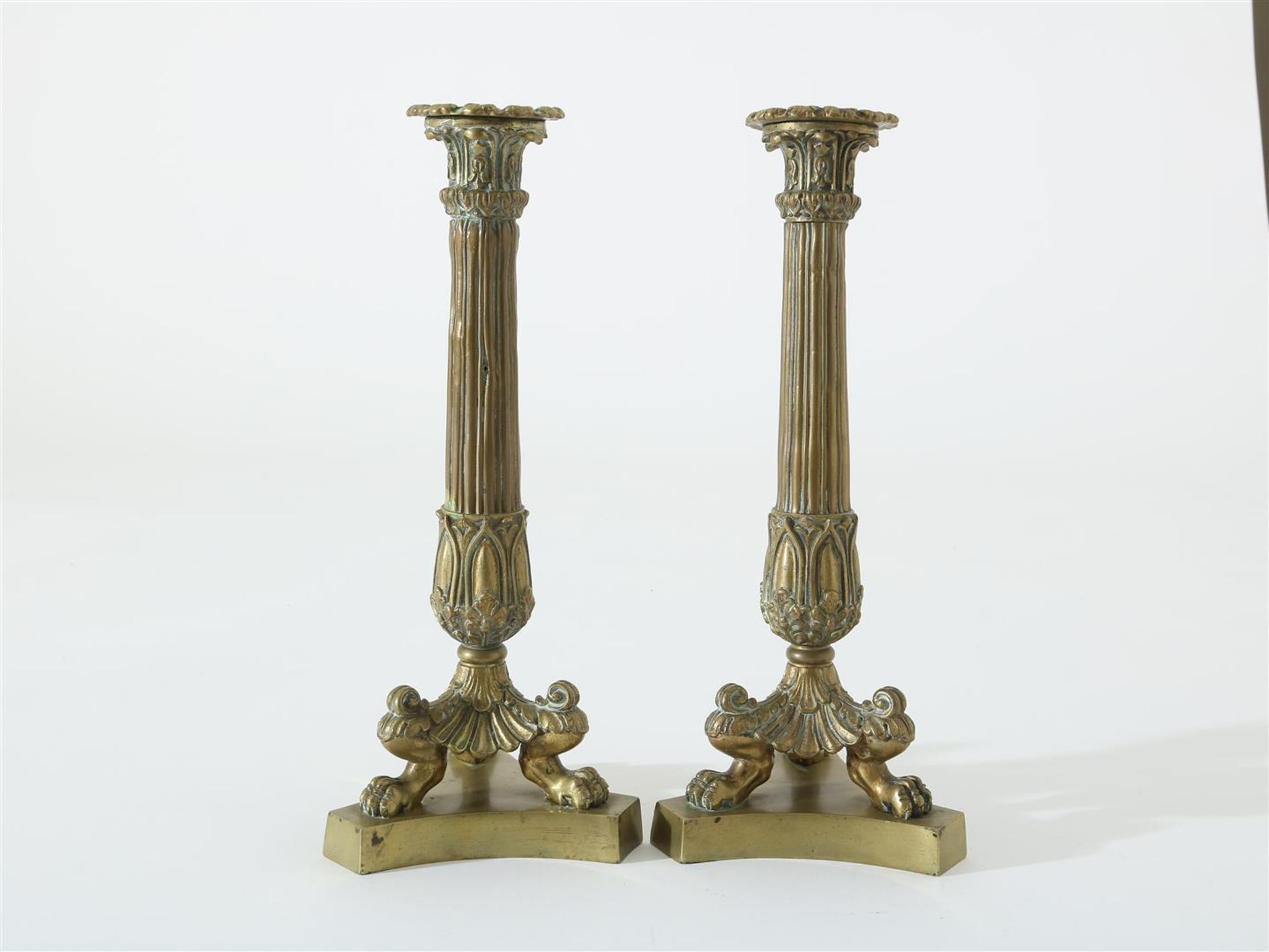 Two brass candlesticks on claw feet, 19th century, height 29 cm.