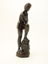 Woman with foot on roller, bronze sculpture,