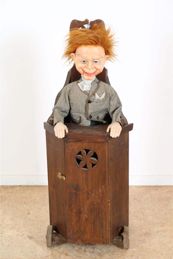 Stained wooden children's chair with panel door and ventriloquist doll , height 93 cm.