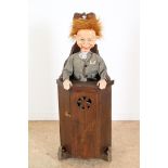 Stained wooden children's chair with panel door and ventriloquist doll , height 93 cm.