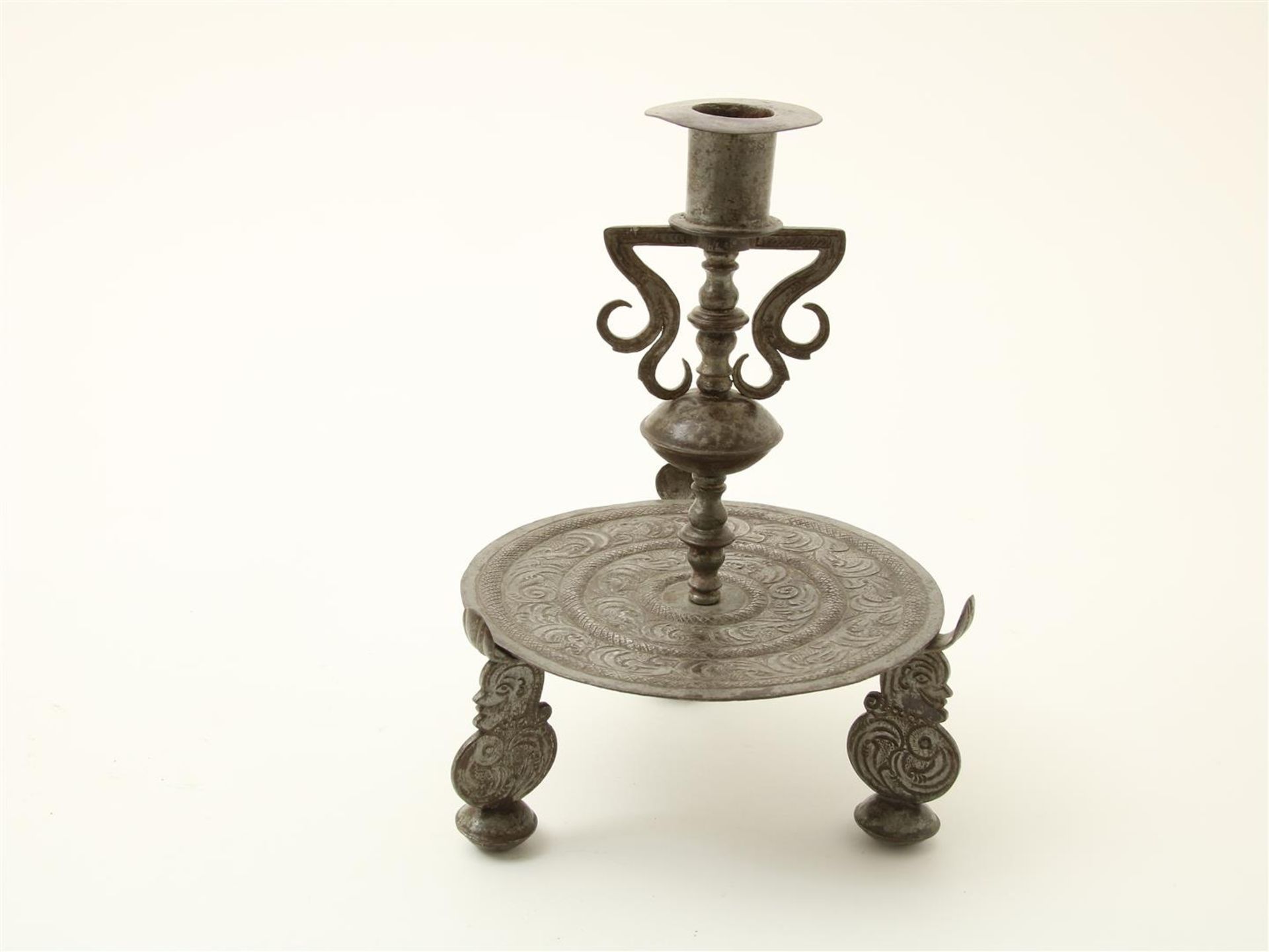 Iron candlestick, decorated with leaf motifs and legs with portraits, possibly Germany, 18th