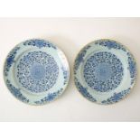 Set of earthenware dishes with central decoration of stylized flowers and edge decoration of