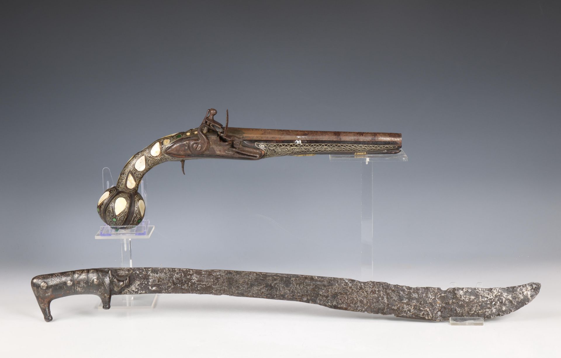 A Eastern style flintlock pistol and a iron sword