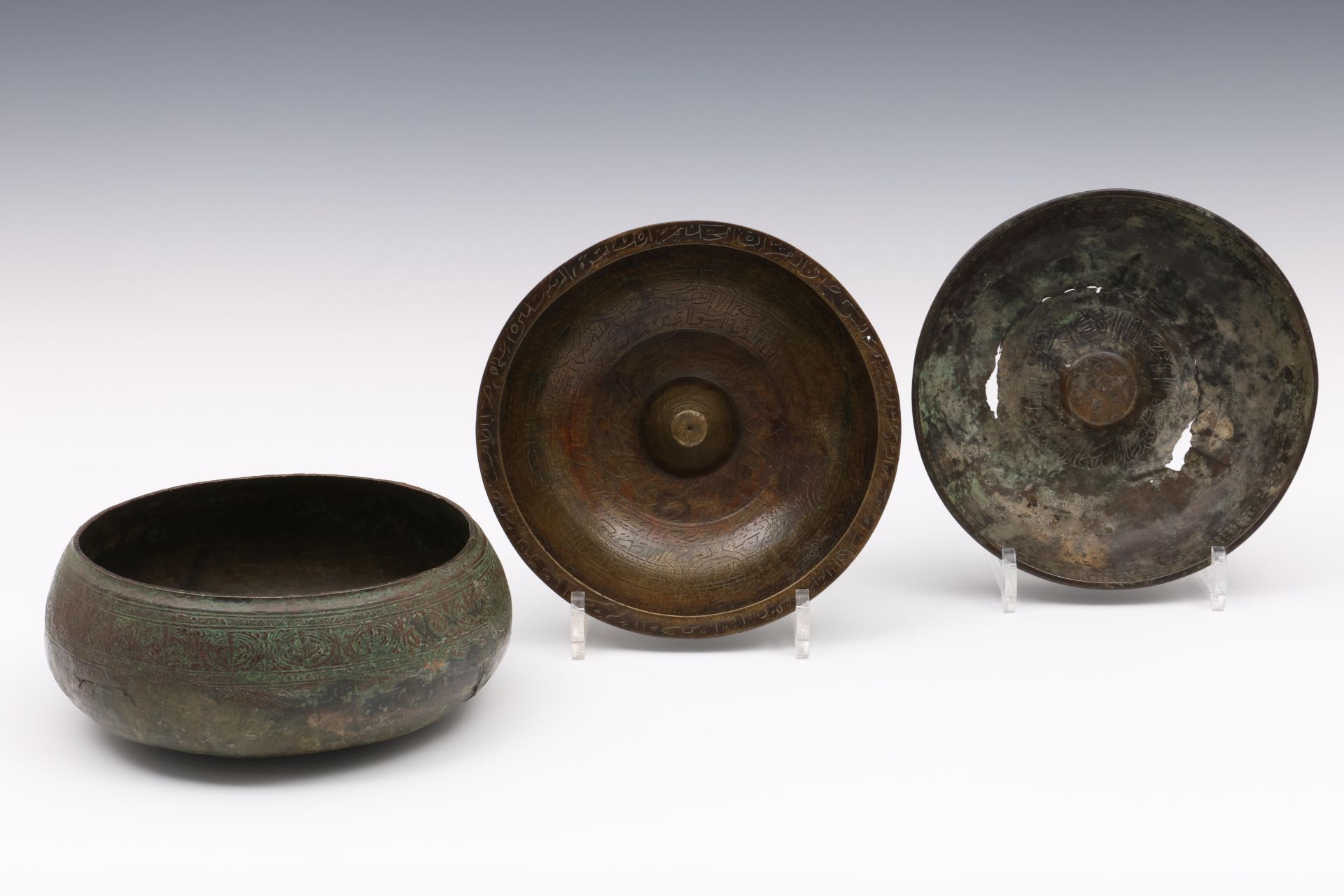 Near Eastern, two bronze bowls with elevated middle, possibly Salavid, 17th century and a Persian bo