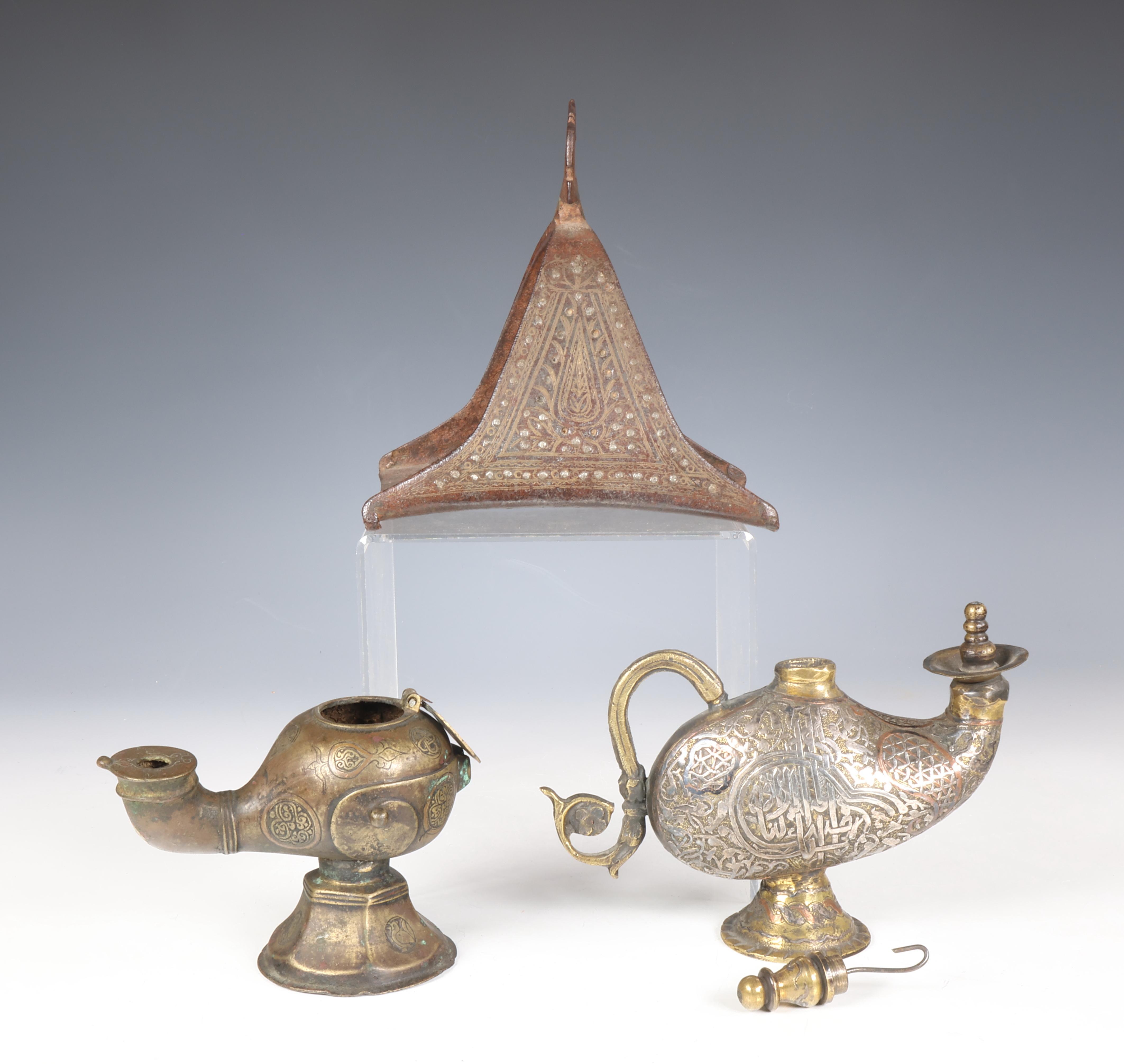 Iran, a metal horse shoe stirrup, a bronze oillamp and a bronze water sprinkler highlighted with sil - Image 3 of 3