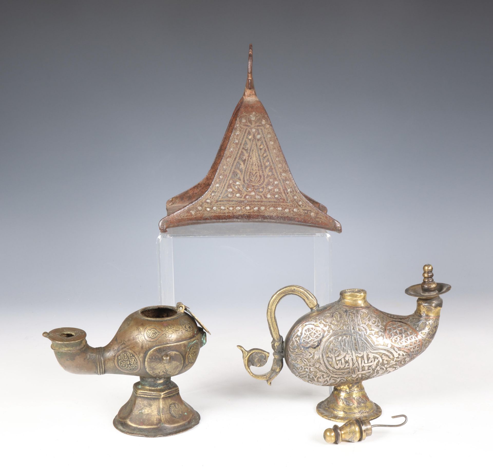 Iran, a metal horse shoe stirrup, a bronze oillamp and a bronze water sprinkler highlighted with sil - Image 3 of 3