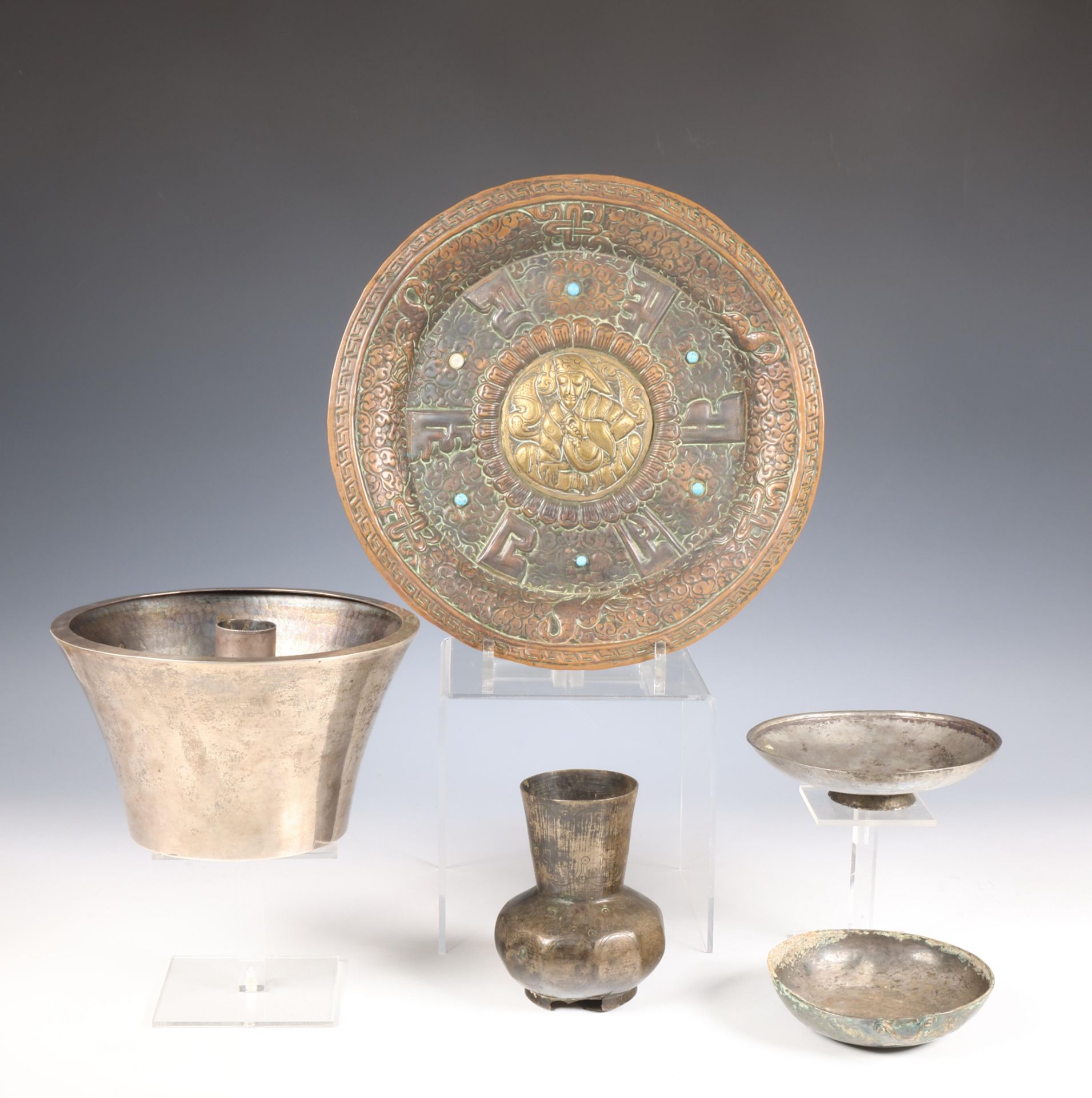 Near Eastern, a collection of four metal-silver alloy objects and a Tibetan metal plate