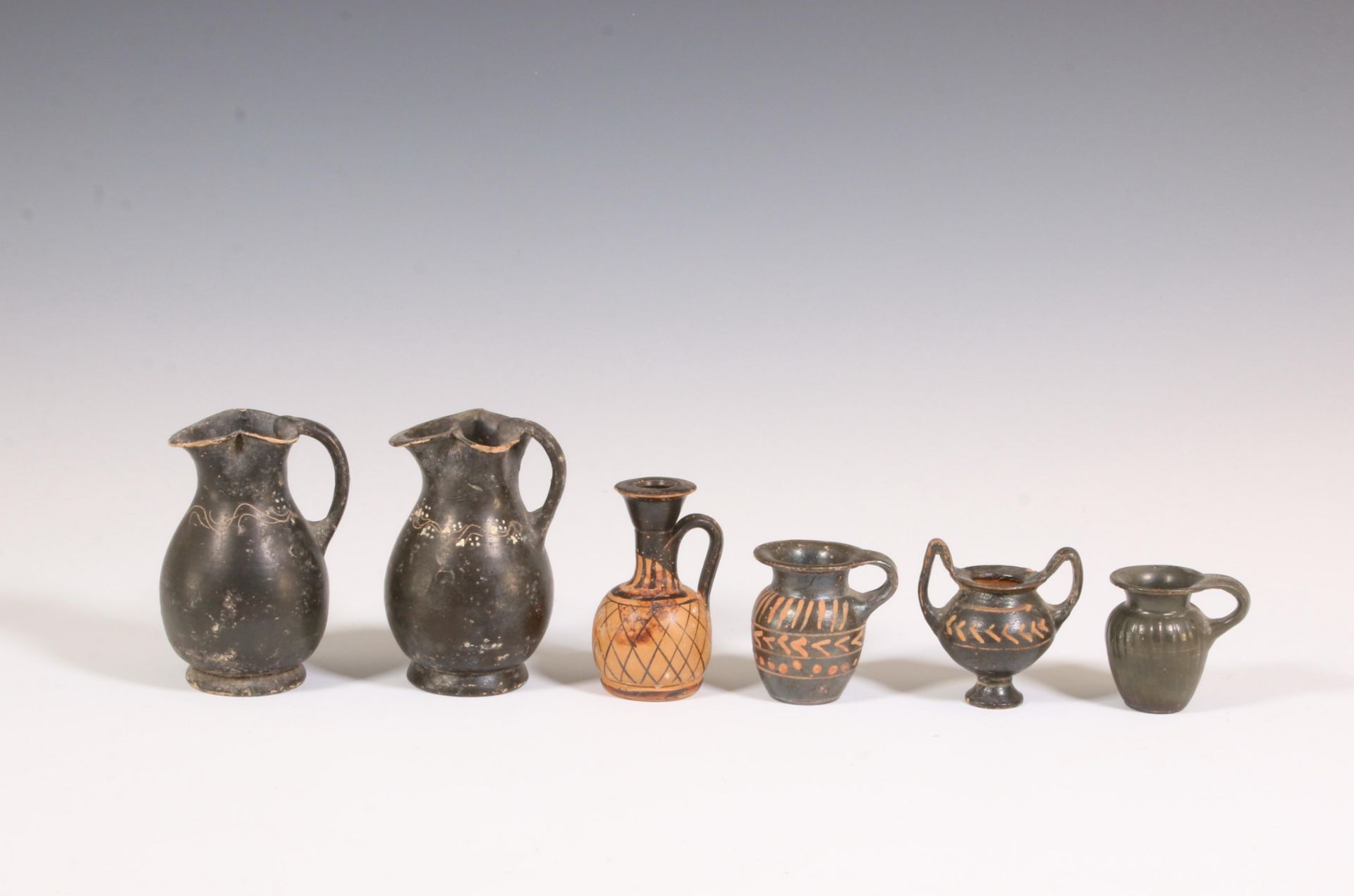 A collection of various Apulian earthenware vases and small pots, 4th century BC;