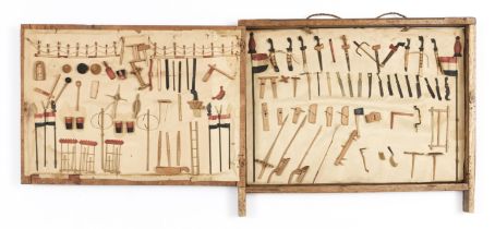 Indonesia, Colonial period,a small display unit showing various implements and weapons.
