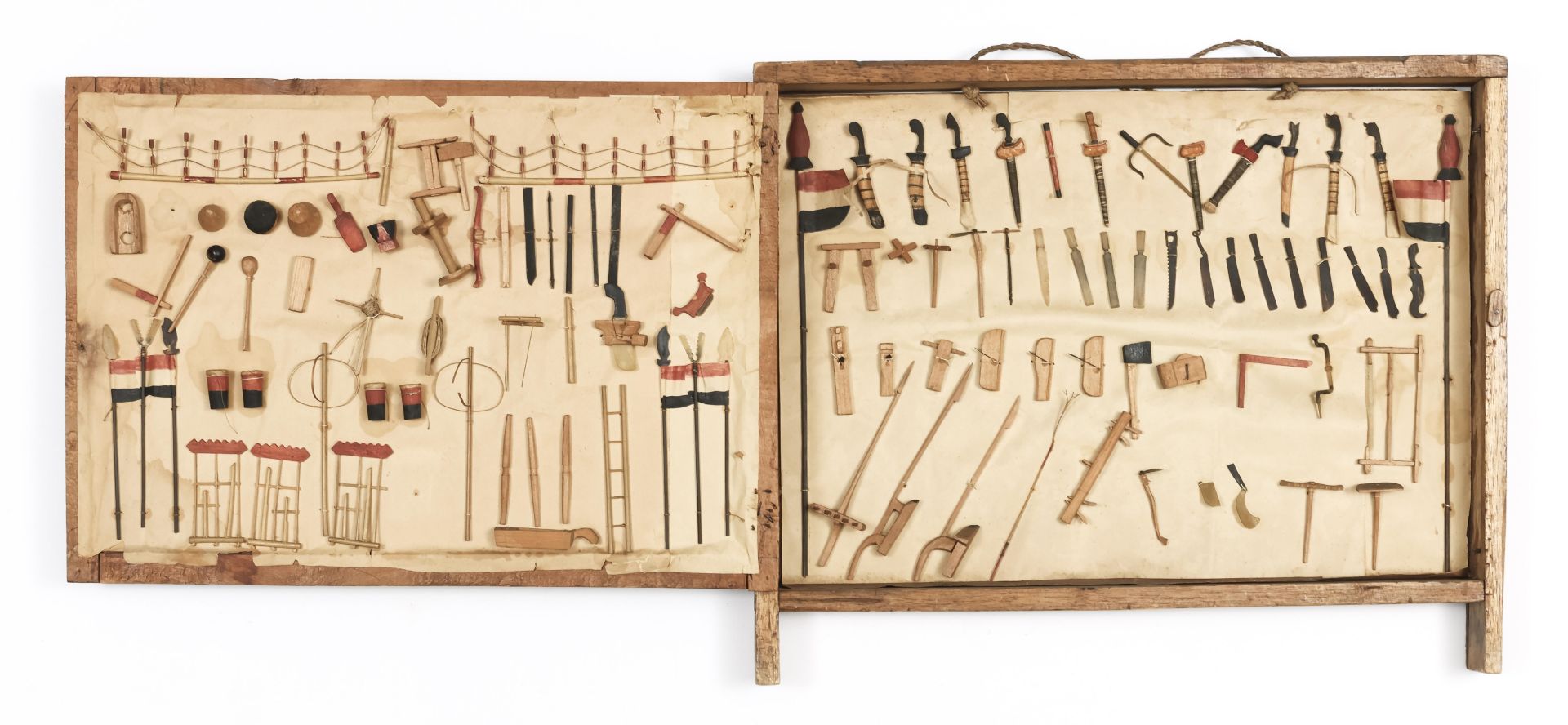 Indonesia, Colonial period,a small display unit showing various implements and weapons.