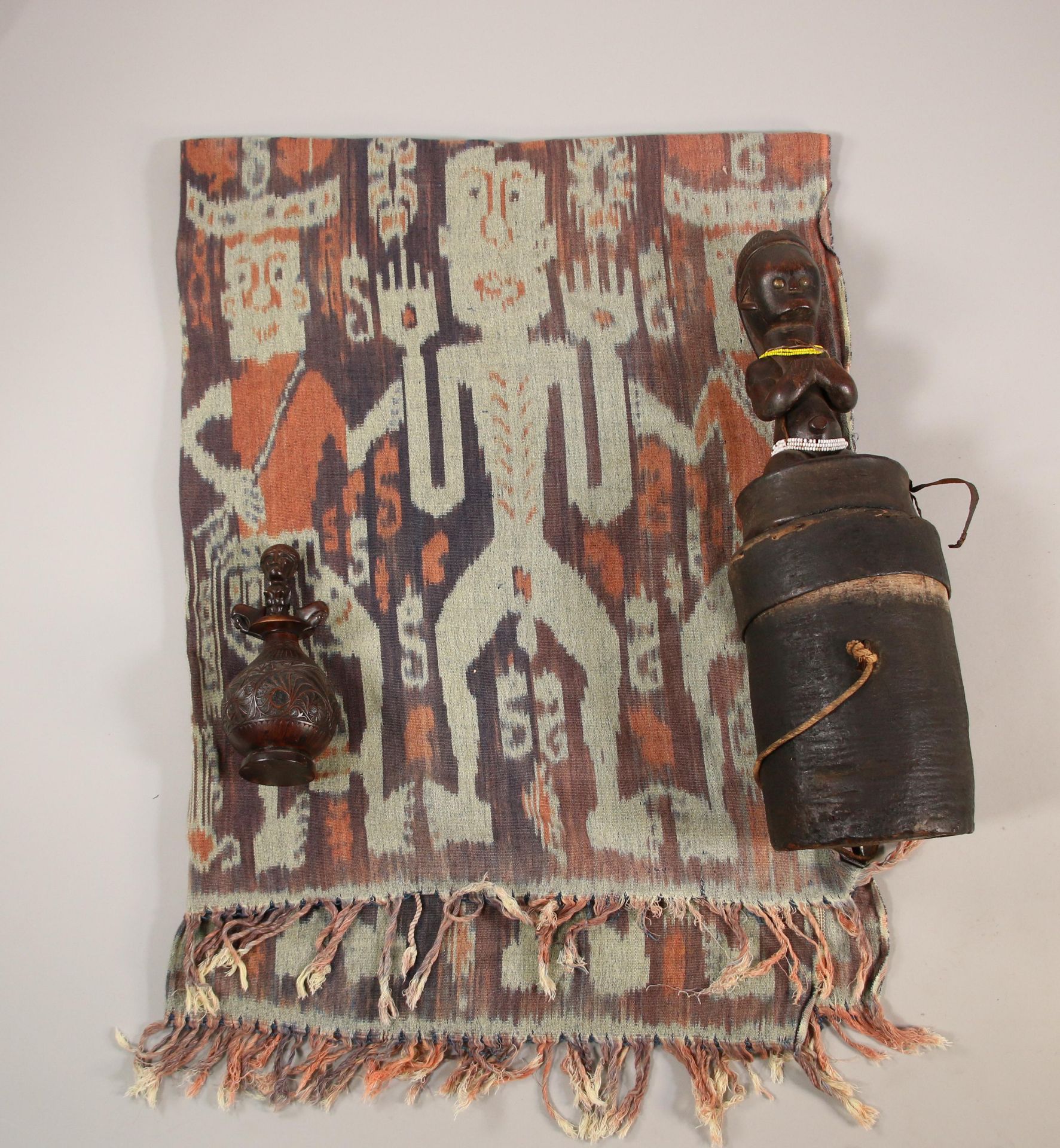 An African bark box with figure on top.