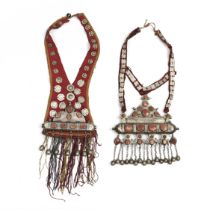 Turkmenistan, two amulet holder pendants, silver set with cornelian, cotton fabric.