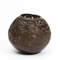 Bali, an open worked coconut shell showing various animals in action.