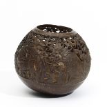 Bali, an open worked coconut shell showing various animals in action.