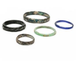 A collection of four antique glass bangles;