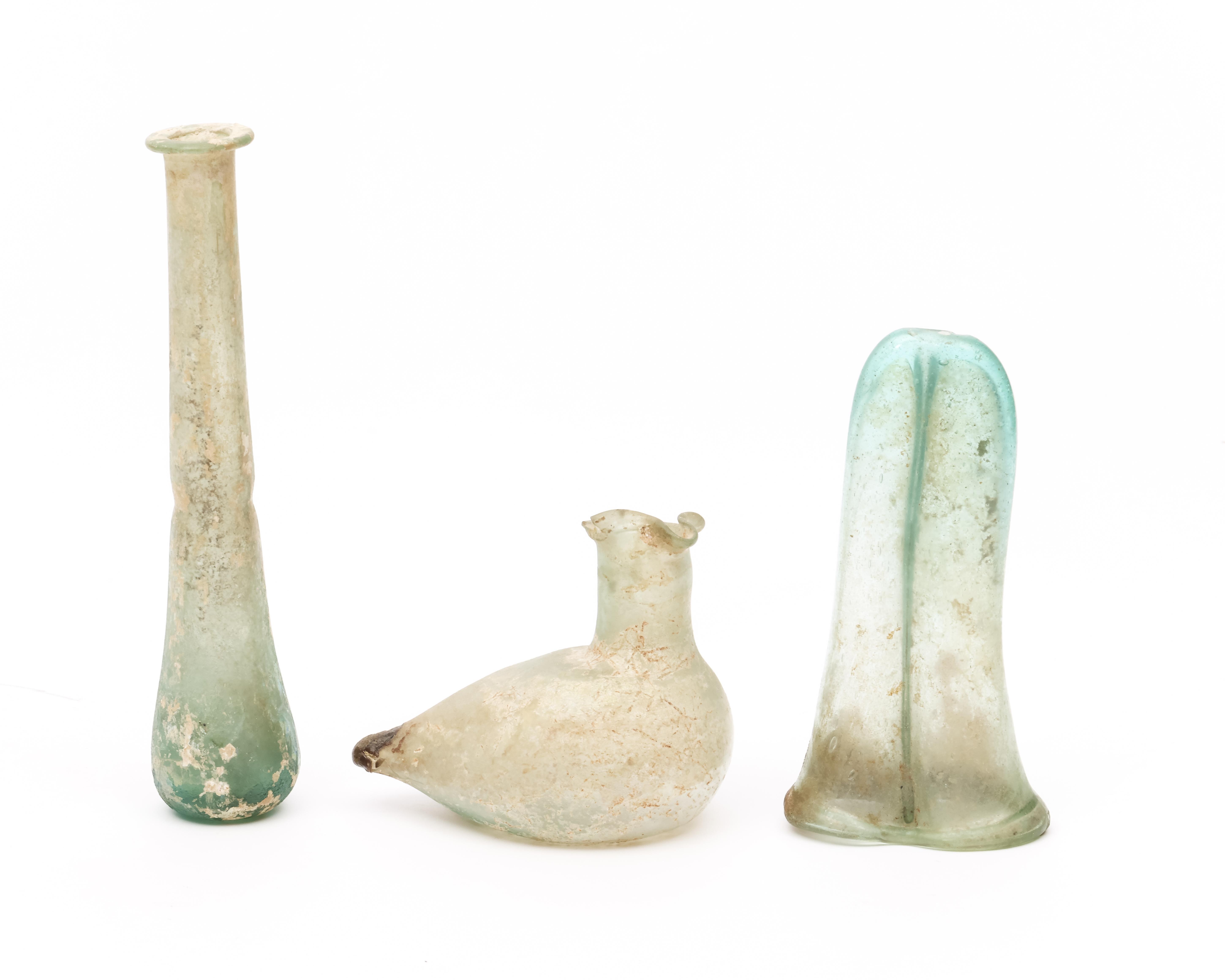 A Roman glass double balsamarium, a bird sprinkler and a long flask, 3r Century BC - Image 5 of 5