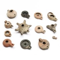 A collection of thirteen Near Eastern terracotta oil lamps