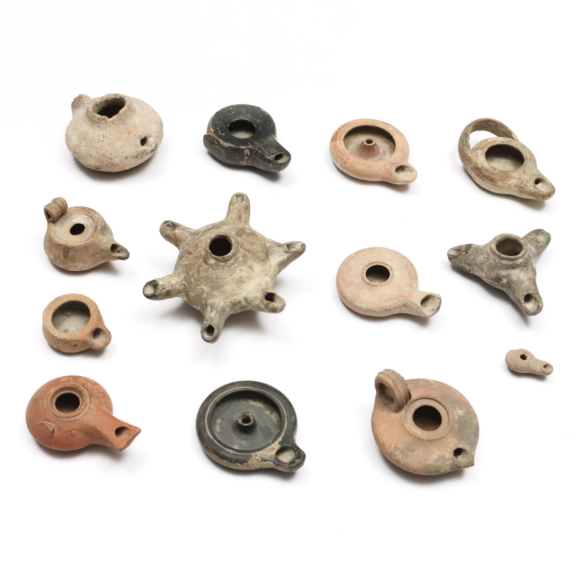 A collection of thirteen Near Eastern terracotta oil lamps