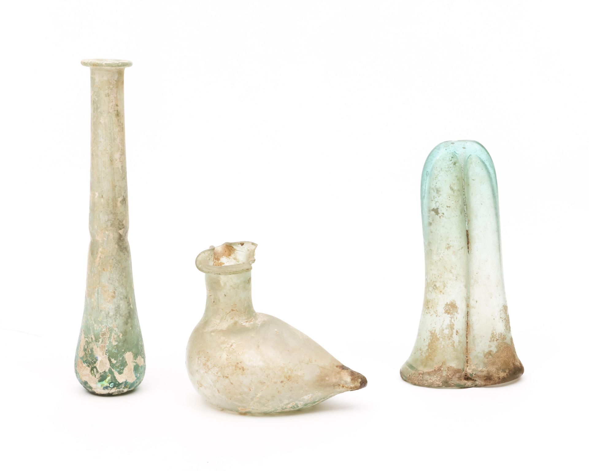 A Roman glass double balsamarium, a bird sprinkler and a long flask, 3r Century BC