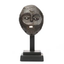 DRC., Lega, a carved mask;