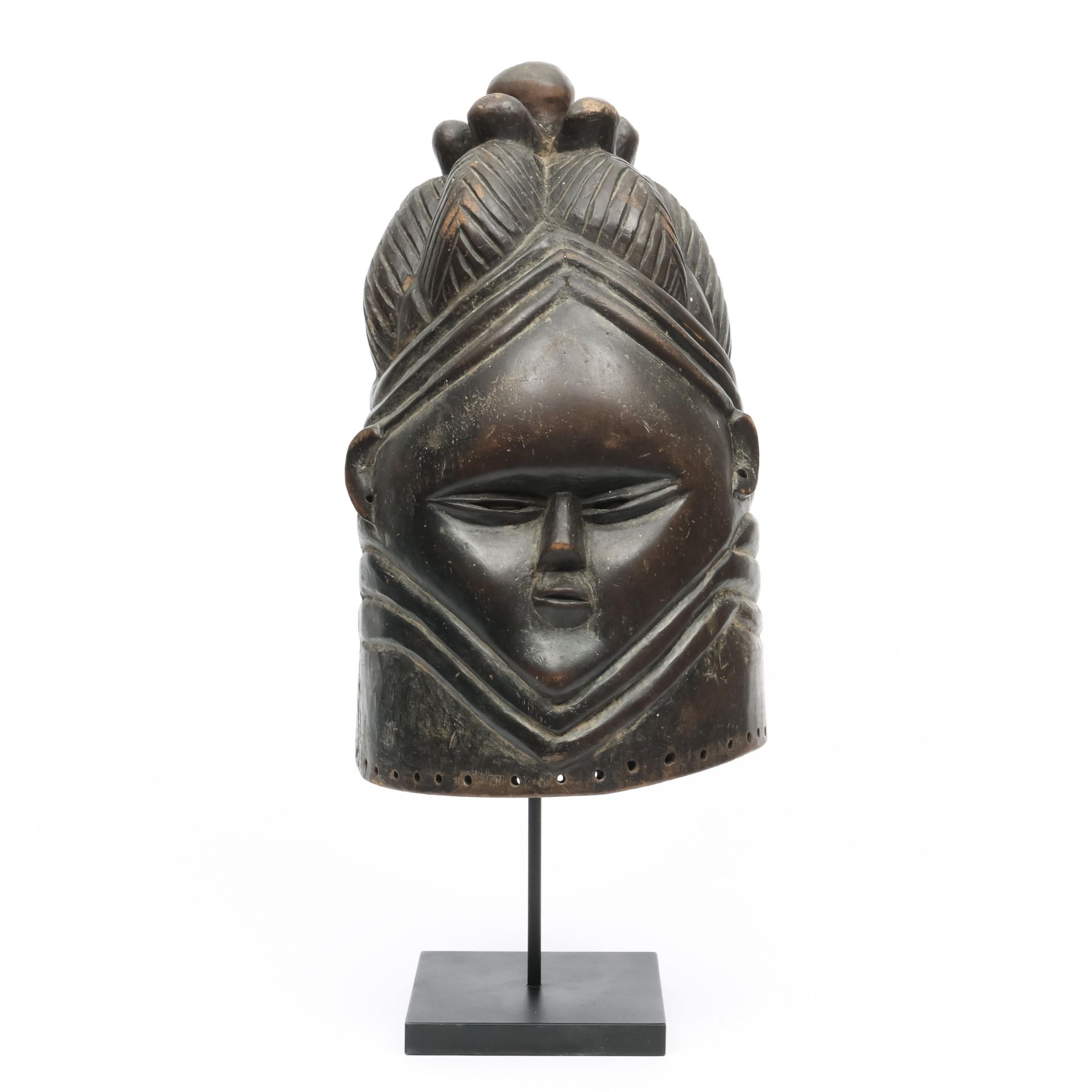 Sierra Leone, Mende, bundu helmet mask, showing a young girl's face, hairdo in tresses.