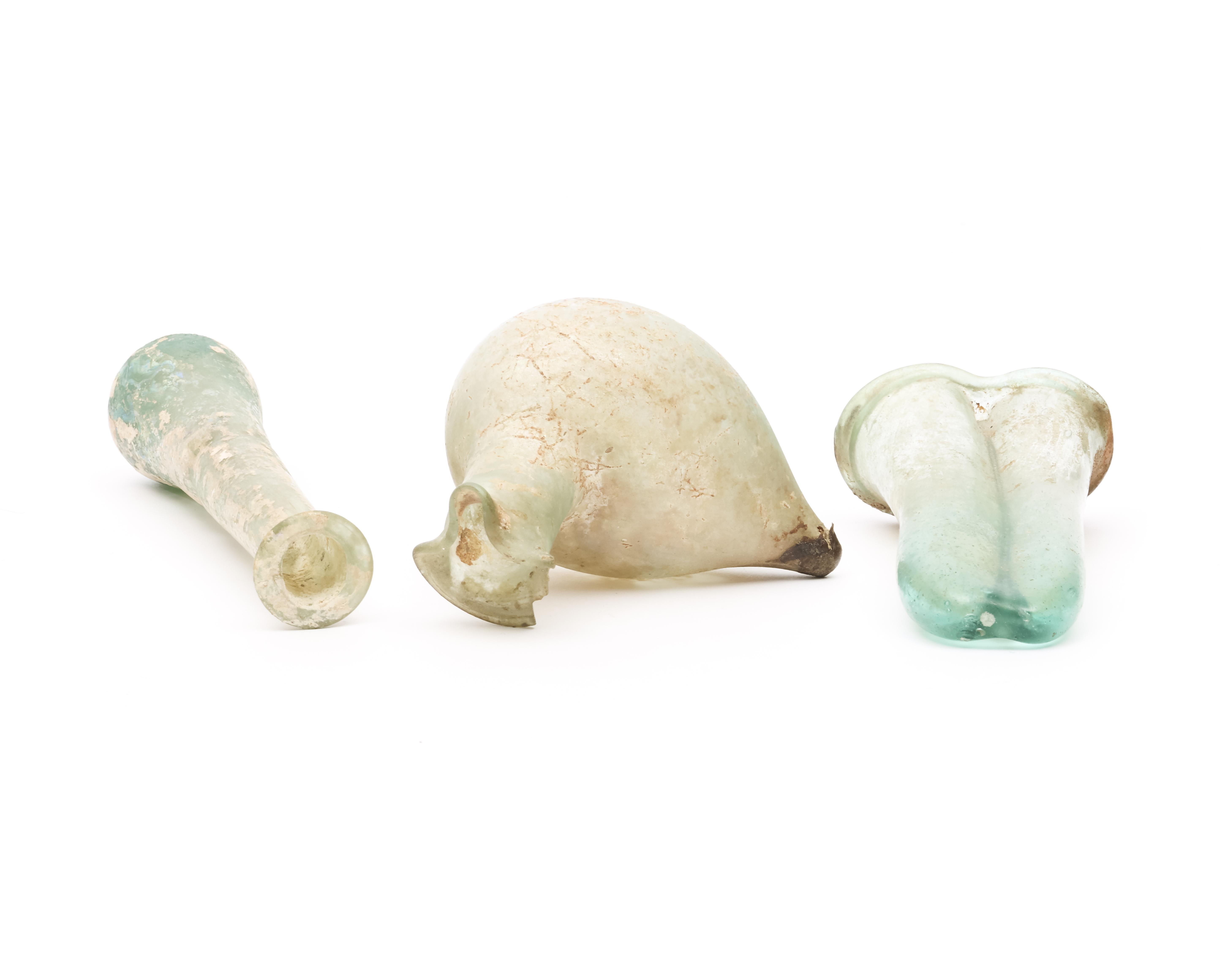 A Roman glass double balsamarium, a bird sprinkler and a long flask, 3r Century BC - Image 3 of 5