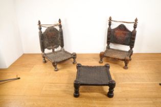 Pakistan, Swat Valley, two carved wooden low chairs and a stool,