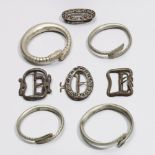 Indonesia, a collection of four Javanese buckles and four metal bangles.