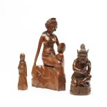 Bali, a sculpture of a seated woman holding a mirror; herewith a standing pregnant woman and a squat