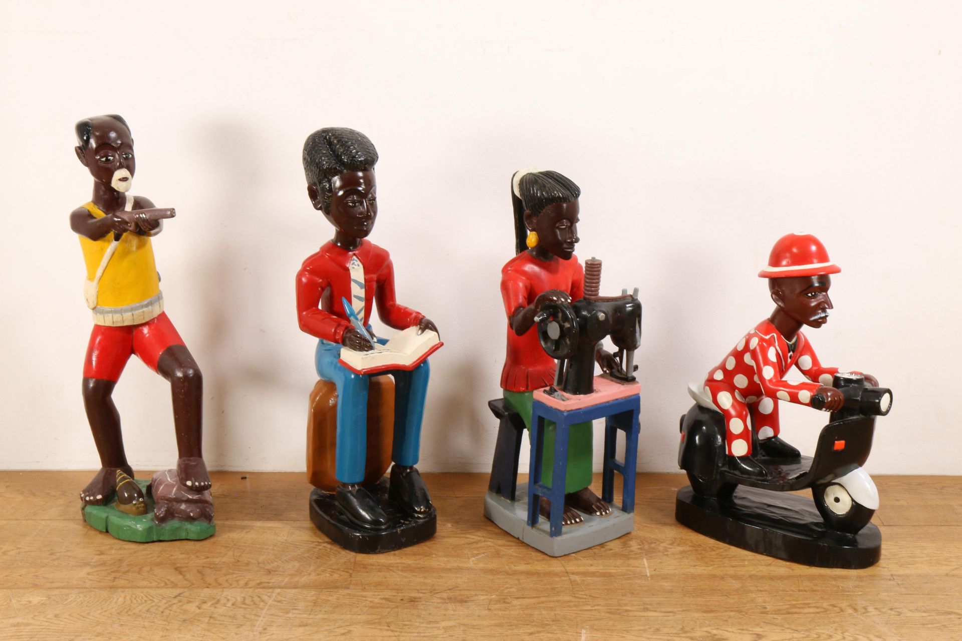 Ivory Coast, four carved and painted Colon figures;