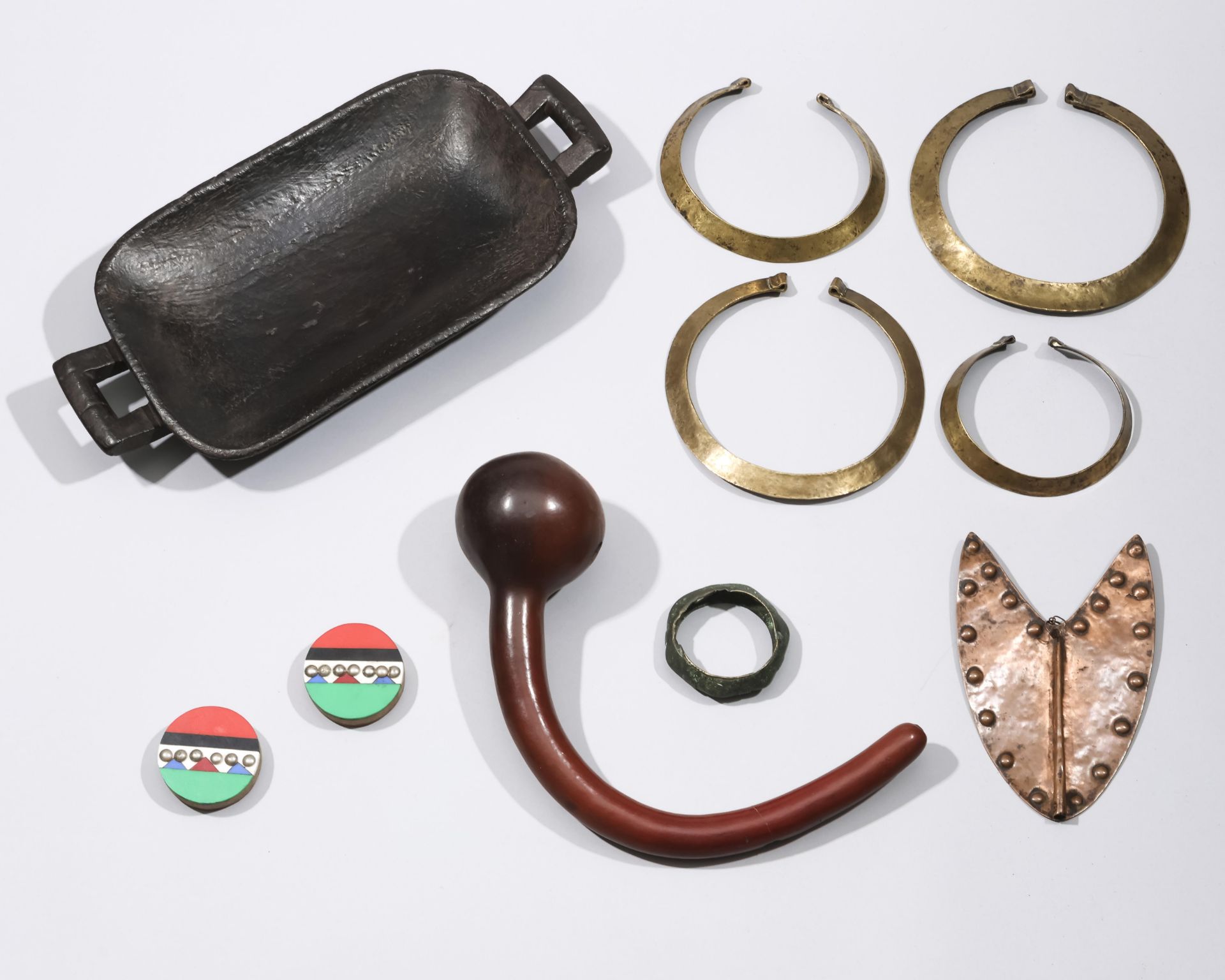 A collection of African objects, consisting of a gourd pipe, two Zulu ornaments, a Kuba tray and thr