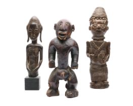Africa, an assorted lot of three various figures.